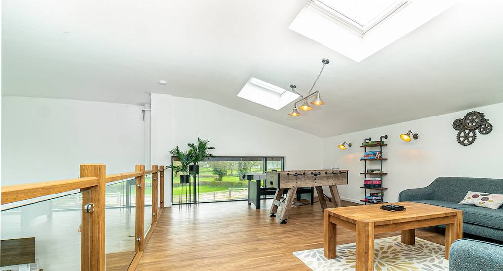 Pool and football table in the Mezzanine Games Room at Tree View Party House