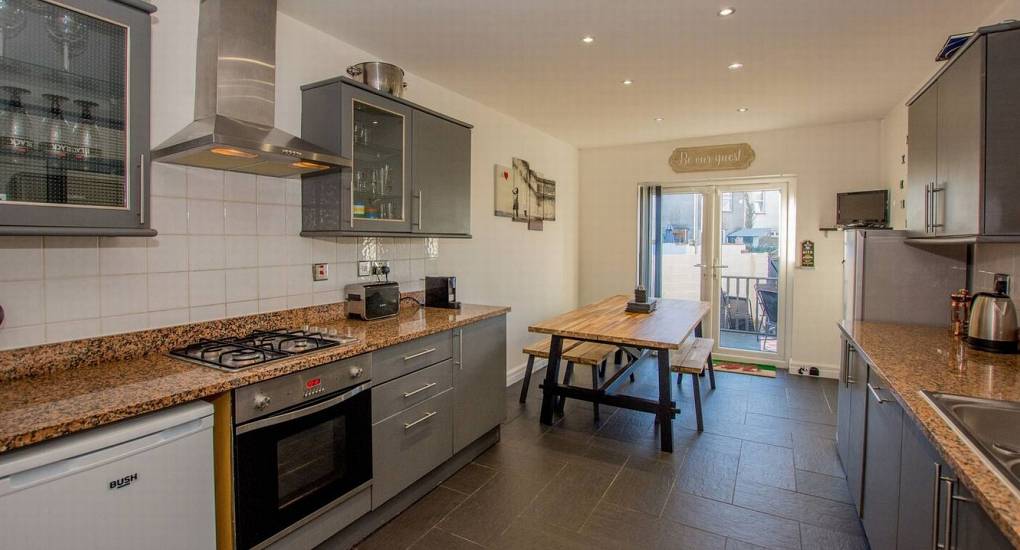 Another view of the kitchen area with the dining areas and conservatory in the background