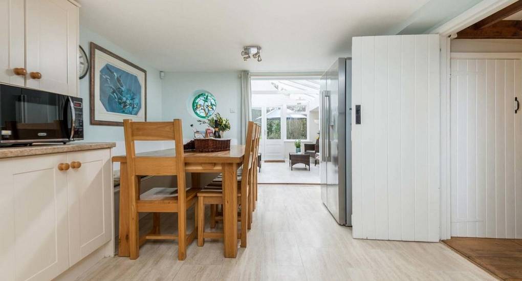 View looking through the kitchen to the conservatory in the Secret Garden New Forest party house