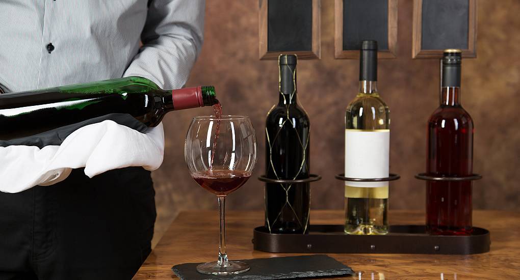 Wine waiter preparing to pour a taster