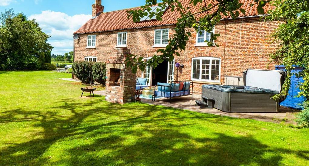 Garden view of house and hot tub