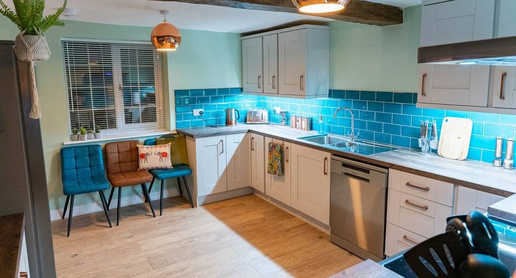 Fully fitted kitchen with feature blue tiles