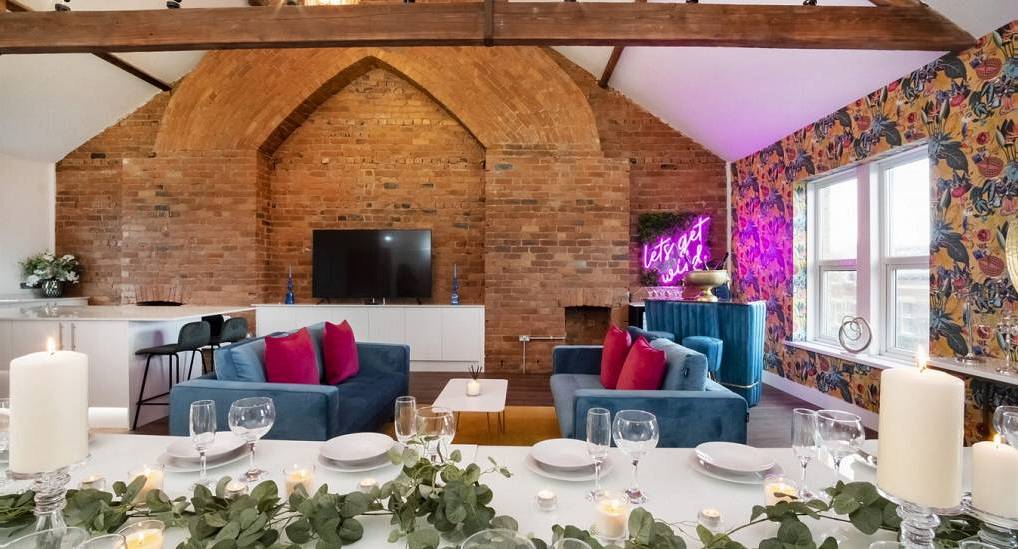 The exposed brick arch dining room and lounge at Shire Manor, a central York party house with pool table for 20.