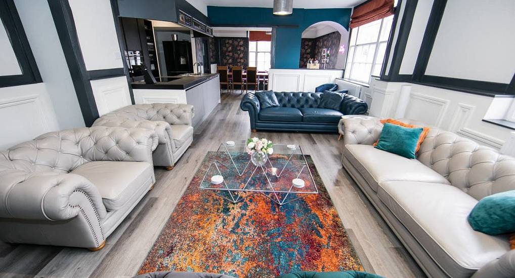 The modern Chesterfield lounge room at The Dales, a central York hen party house for large groups sleeping 16.