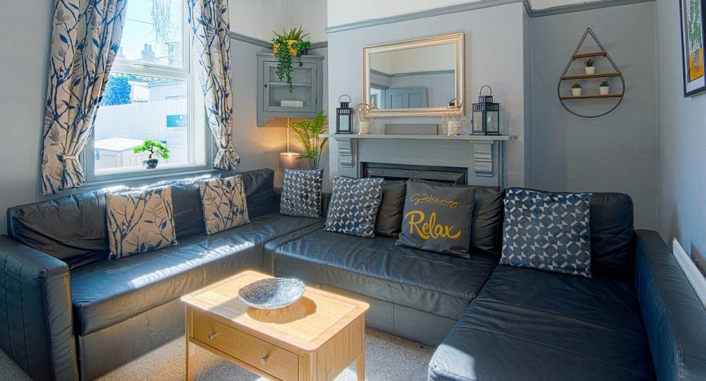 The spacious corner sofa living room at The Red House, a converted central York hen party townhouse for large groups.